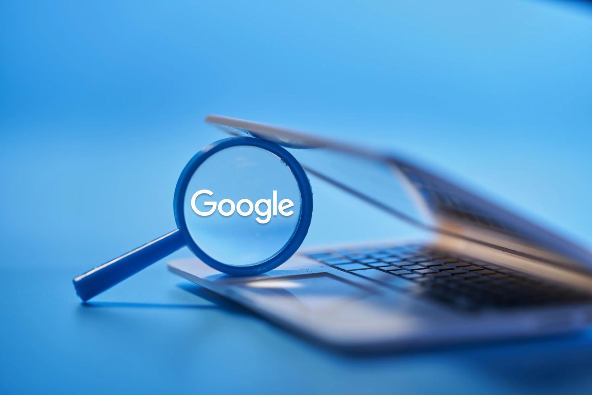 Google logo under magnifying glass.