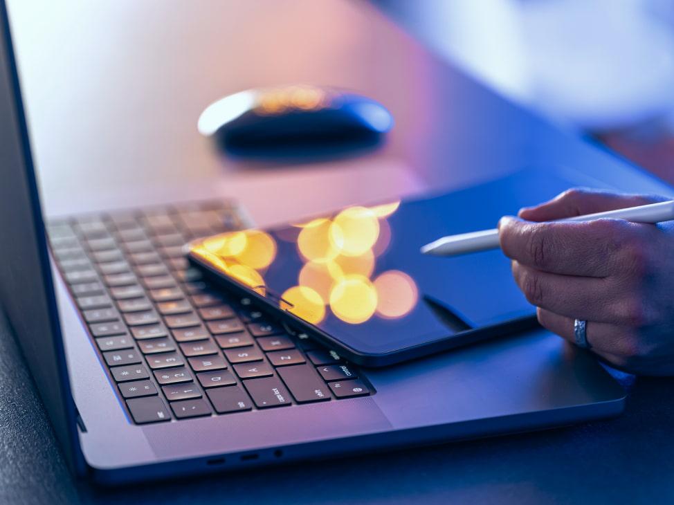 Hand with stylus on tablet